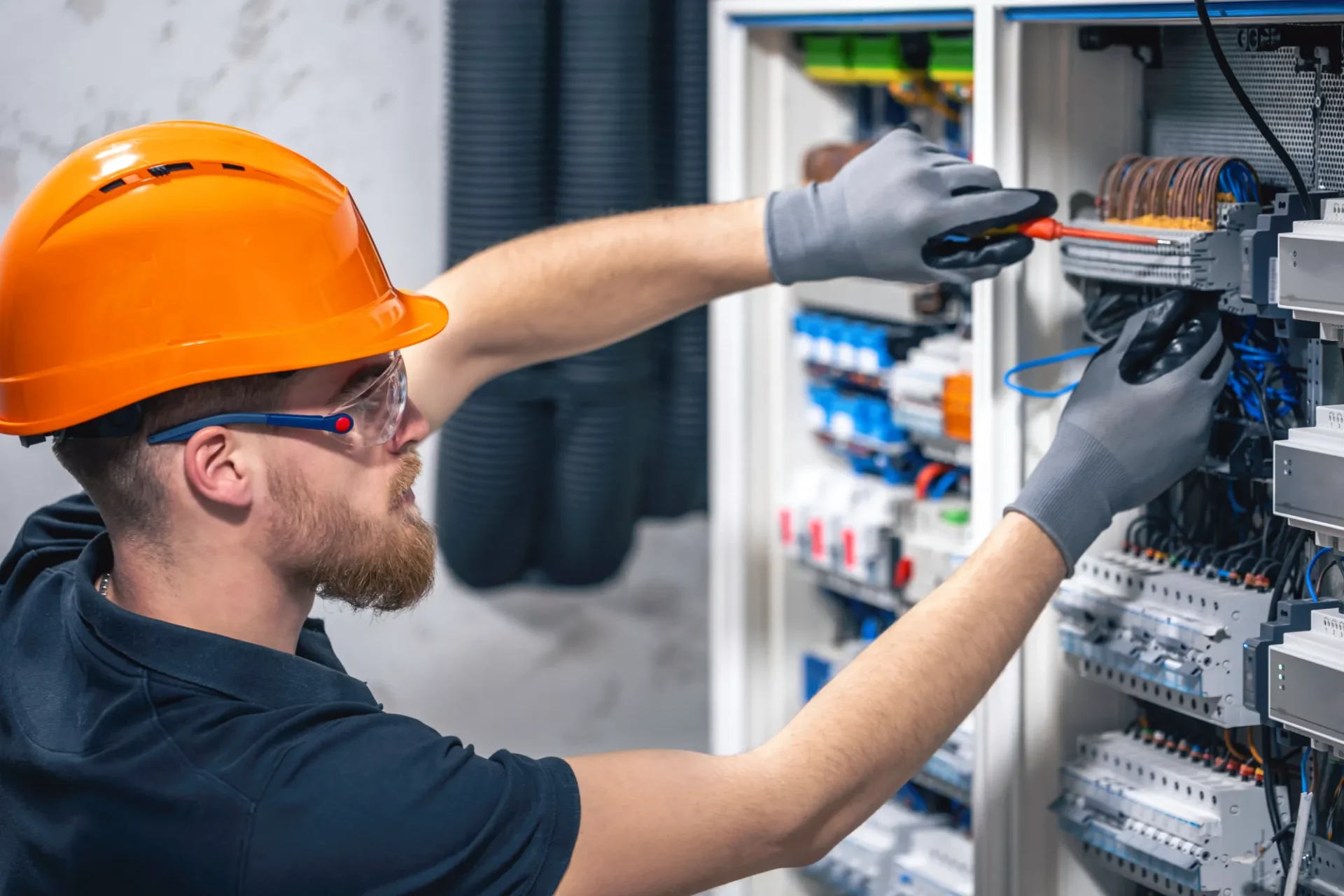 Electrician working on electrical panel.