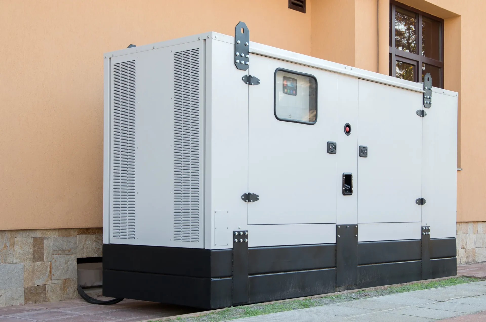 White generator unit outside building.